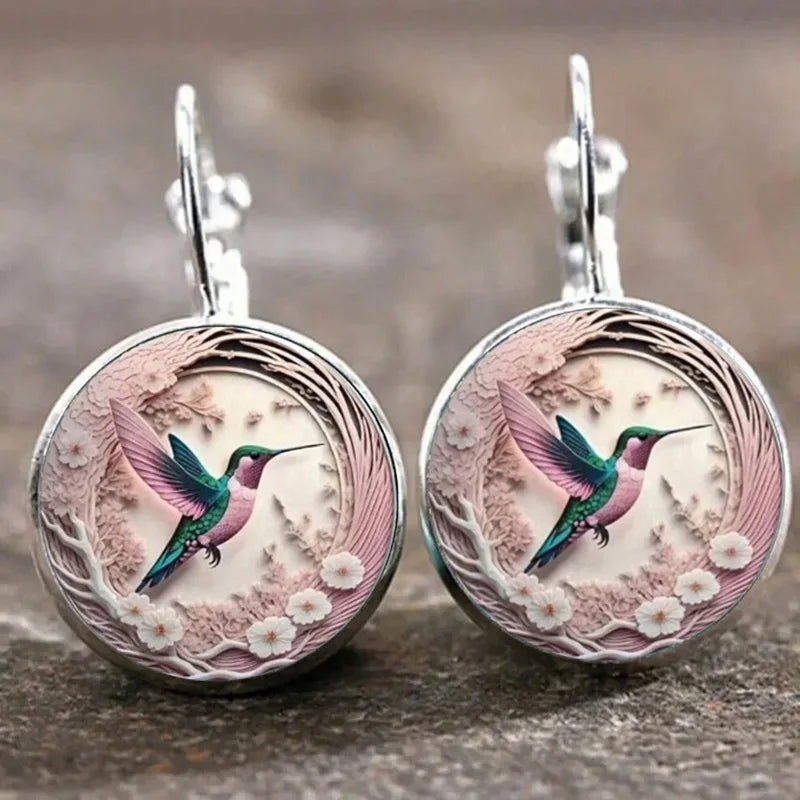 Hummingbird pendant necklace under a glass dome