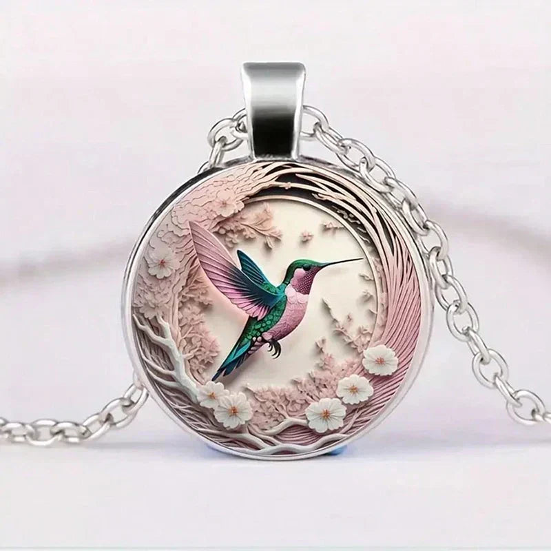 Hummingbird pendant necklace under a glass dome